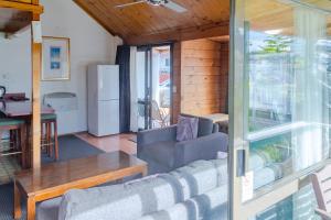 a living room with a couch and a table at New Haven Motel in Auckland