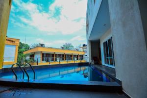 a swimming pool in front of a building at Kethumathee Hotel & Banquet in Ratnapura