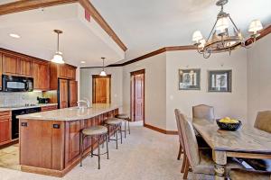 a kitchen and dining room with a table and chairs at Mc308 Mill Club Condo in Copper Mountain