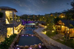 an aerial view of a resort pool at night at Philea Resort & Spa in Malacca