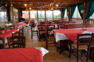 a restaurant with red and white tables and chairs at Agriturismo Cameli in Certaldo +7 photos