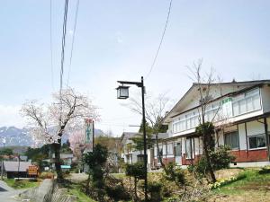 a street light on a pole in front of a house at Togakushi- Kogen Minshuku Rindo in Nagano