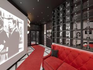 a red couch in a room with a wall of wine bottles at Design Hotel Sofit in Moscow