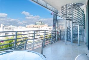 a balcony with a view of a city skyline at Penthouse De Soleil South Beach - on Ocean Drive Miami Beach in Miami Beach