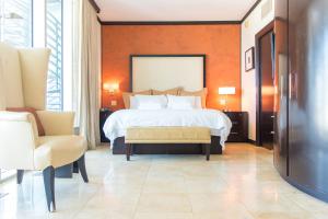 a hotel room with a bed and a chair at Penthouse De Soleil South Beach - on Ocean Drive Miami Beach in Miami Beach