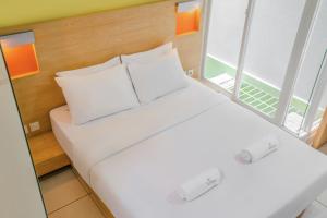 Uma cama ou camas num quarto em LeGreen Suite Poso