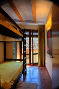 a bedroom with two bunk beds and a balcony at Apartamentos Casa Molinero in Buera