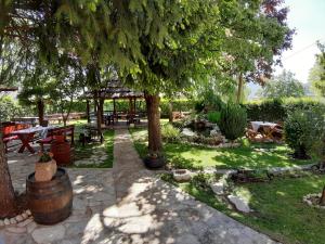 a garden with a picnic table and a tree at Brana Gorica Apartments in Trebinje