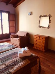 a living room with a couch and towels on the floor at APARTAMENTOS RURALES AZABACHE in Villaviciosa
