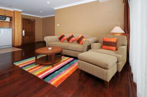 
a living room filled with furniture and a couch at Admiral Suites Bangkok in Bangkok

