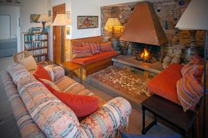 a living room with a couch and a fireplace at Cottage 215 - Claddaghduff in Cleggan