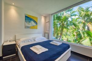 a bedroom with a bed and a large window at Villa Zagara Garden Spectacular Sea View in Taormina in Taormina +162 photos