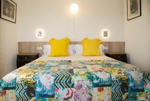ein Schlafzimmer mit einem großen Bett mit gelben Kissen in der Unterkunft Torre Orquidaceae - Plus Costa Brava in L'Estartit + 37 Fotos