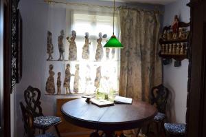 een kamer met een tafel en stoelen en een raam bij Villa Merzbach - Wohnen wie im Museum mit Komfort in Untermerzbach
