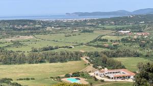 an aerial view of a estate with a swimming pool in a field at Residence Hotel Monte Ricciu in Alghero