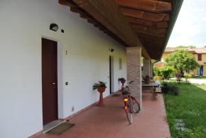 a bike parked on a brick sidewalk next to a house at Agriresidence San Pietro in Bibione