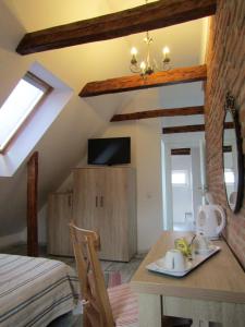 a room with a table and a room with a bed at Blue House in Braşov