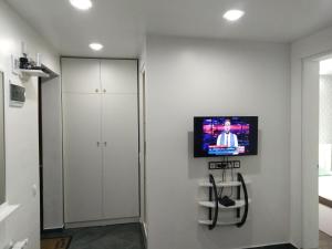 a room with a flat screen tv on the wall at Apartment Eteri in Batumi