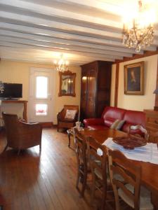 a living room with a table and a red couch at Welcome in Authuille