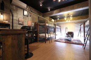 a room with two bunk beds and a bar at TOMARU MORISITA HOUSE in Tokyo