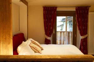 Posteľ alebo postele v izbe v ubytovaní Le Petit Coeur Residence De Montagne