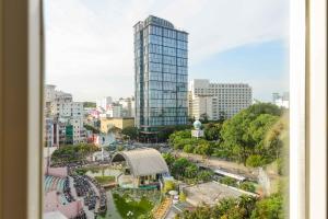 a view of a city with a tall glass building at Saigonciti Hotel A in Ho Chi Minh City