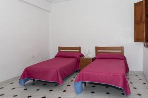 Ein Bett oder Betten in einem Zimmer der Unterkunft La Ponderosa, 4º-21