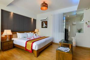 a bedroom with a bed and a television in it at Saigonciti Hotel A in Ho Chi Minh City +65 photos