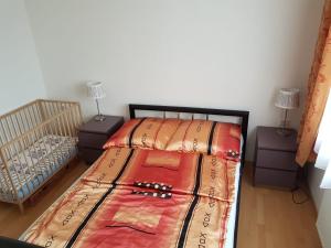 a bedroom with a bed and two night stands at Ruhige Ferienwohnung nahe Ostsee (30km) in Voigtsdorf/Nordvorpommern in Glewitz