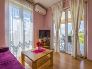 a living room with a purple couch and a table at Dolores in Crikvenica
