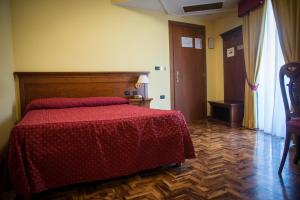 Postel nebo postele na pokoji v ubytování Albergo Ristorante Uliveto