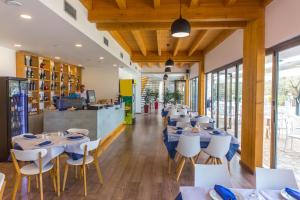 a restaurant with tables and chairs and a counter at Alban Eco Hotel in Dhërmi
