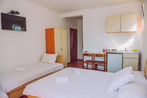 Postel nebo postele na pokoji v ubytování Apartmani Lasta