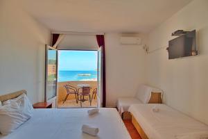 een kamer met 2 bedden en uitzicht op de oceaan bij Apartmani Lasta in Dobra Voda
