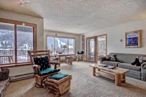 a living room with a couch and a table at Cri221 Cinnamon Ridge Condo in Keystone