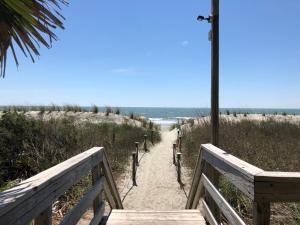 a wooden staircase leading to a beach with the ocean at Water Pointe I 503 Condo in Myrtle Beach