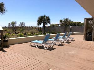 a row of lounge chairs sitting on a patio at Water Pointe I 503 Condo in Myrtle Beach