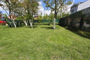 a grassy yard with trees and a fence at Villa Rita in Ohrid