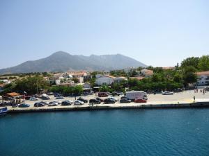 a group of cars parked in a parking lot next to the water at Studios La Kastania in Therma