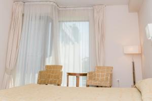Postel nebo postele na pokoji v ubytování Hotel Burgas