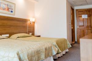 Postel nebo postele na pokoji v ubytování Hotel Burgas