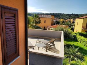 a balcony with chairs and a view of a city at Beb oasi marina in Campofelice di Roccella