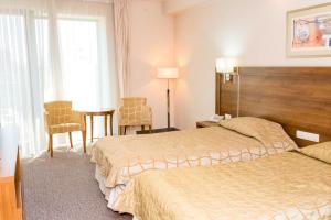 Postel nebo postele na pokoji v ubytování Hotel Burgas
