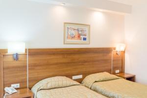 Postel nebo postele na pokoji v ubytování Hotel Burgas