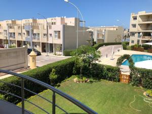a view from a balcony of a yard with a pool at Sedra in north coast Chalet in Qaryat Shurūq