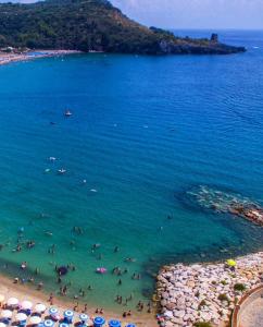 een groep mensen in het water op een strand bij Marea Retreat Apartments in Marina di Camerota