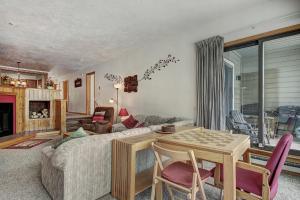 a living room with a table and a couch at 2062 The Pines Condo in Keystone