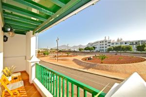 a balcony with a view of a street and buildings at Apartamento Dorada Alto in Playa Blanca