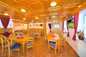 a dining room with wooden tables and chairs at Pension Villa Stella in Špindlerův Mlýn