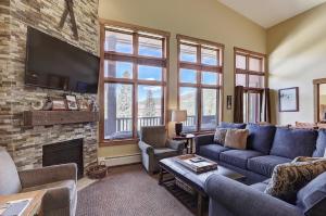 a living room with a couch and a fireplace at 8890 The Springs Condo in Keystone